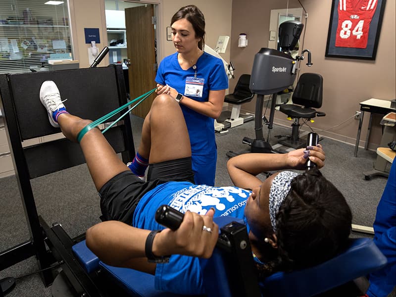 Atkinson receives treatment from physical therapist Currie Fletcher.